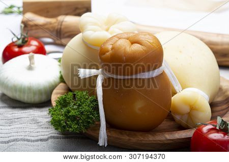 Italian Provolone Or Provola Caciocavallo Hard And Smoked Cheeses In Teardrop Form Served On Olive T