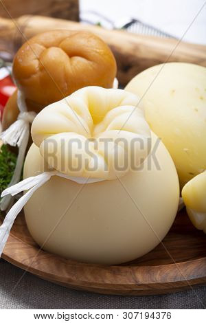 Italian Provolone Or Provola Caciocavallo Hard And Smoked Cheeses In Teardrop Form Served On Olive T