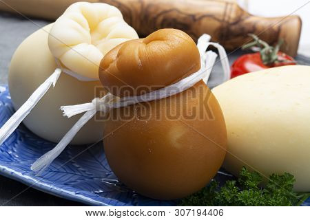 Italian Provolone Caciocavallo Aged And Smoked Cheeses In Teardrop Form Served On Blue Plate Close U