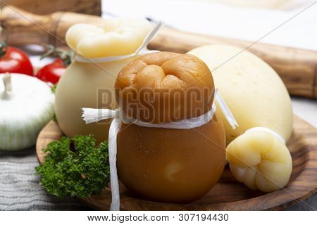 Italian Provolone Or Provola Caciocavallo Hard And Smoked Cheeses In Teardrop Form Served On Olive T