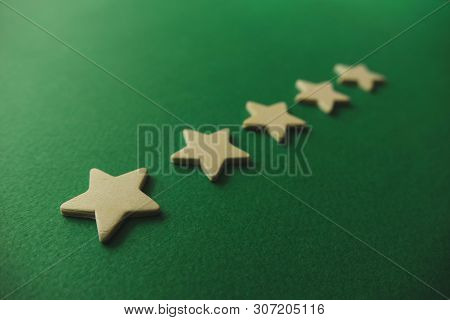 Five White Stars On A Green Background