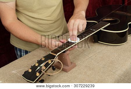 Musical Instrument Guitar Repair And Service - Worker Moistening And Impregnation Of An Fingerboard 