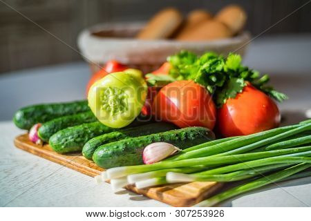 Fresh Seasonal Vegetables On Wooden Board On Table.