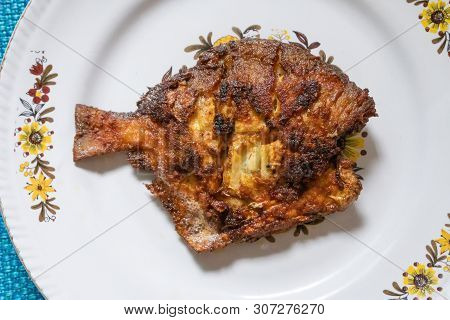 A Fried Pomfret Fish Served On A White Decorated Platter, Spicy Indian Food. Pomfrets Are Perciform 