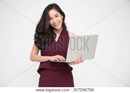 Portrait Of An Excited Asian Woman Holding Notebook Computer On White Background, Happiness Female M