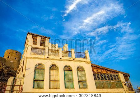 Old, Decaying House Near The Fort Tower With Blue Sky Background. From Muttrah, Muscat, Oman.