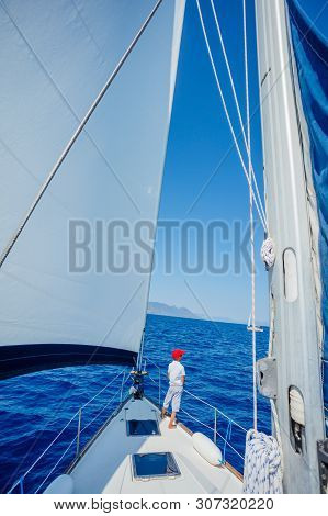 Little Boy On Board Of Sailing Yacht On Summer Cruise. Travel Adventure, Yachting With Child On Fami