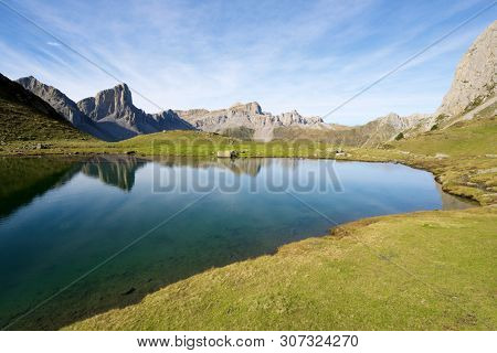 Peaks reflected in Ansabere Lake. Lescun Cirque. Aspe Valley, Pyrenees, France.