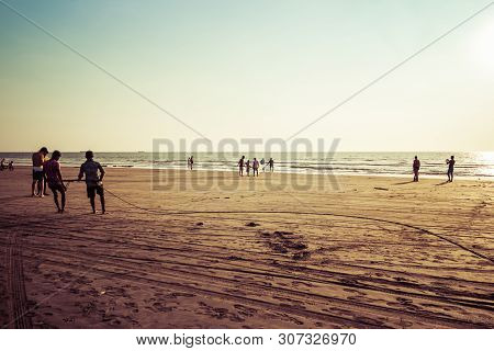 Goa, India - December 20, 2018: Fishermen Fishing With Nets On Morjim Beach