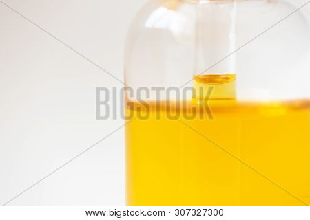 Close-up Level Oil Serum Essence In Glass Bottle On White Background. Skincare Product