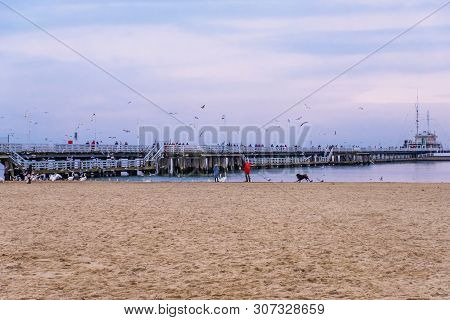 Sopot, Poland - February 06, 2019: The Sopot Pier Is The Longest Wooden Pier In Europe. People Walk 