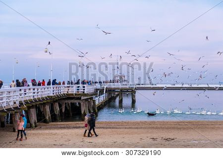 Sopot, Poland - February 06, 2019: The Sopot Pier Is The Longest Wooden Pier In Europe. People Walk 