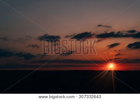 Evening Sky At Sunset Background. Dark Clouds Hanging Above Horizon. Majestic Cloudscape In Blue, Or