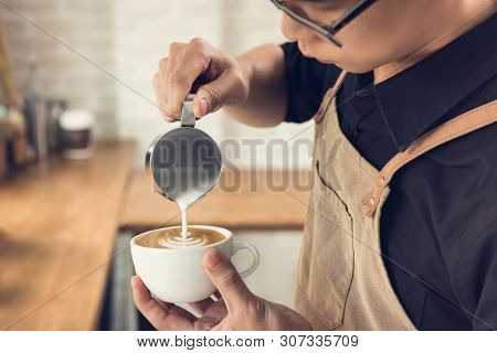 Professional Barista Pouring Steamed Milk Into Coffee Cup Making Beautiful Latte Art Rosetta Pattern