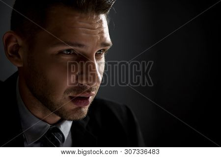 Man In Shadow With Serious Face Staring At Interlocutor, Criminal Interrogation Concept