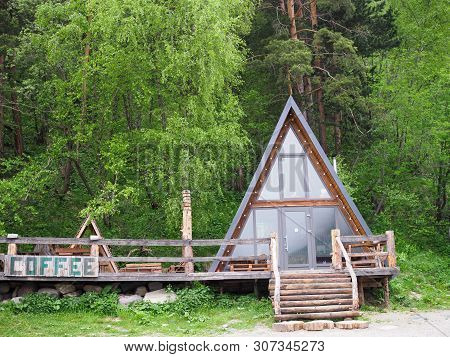 Beautiful Wooden House In The Form Of A Hut In The Forest With The Inscription Coffee. Cheget, Russi
