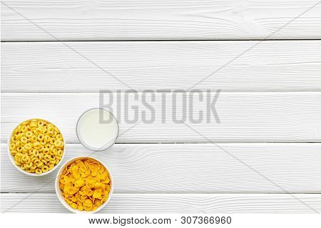Cereals, Oatflakes And Cornflakes With Milk For Healthy Breakfast On White Wooden Background Top Vie