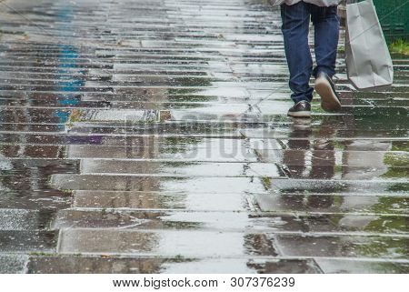 London, Uk - Jun 5, 2019 :  Pedestrian Feet Walking In The Rain In Chiswick Street.