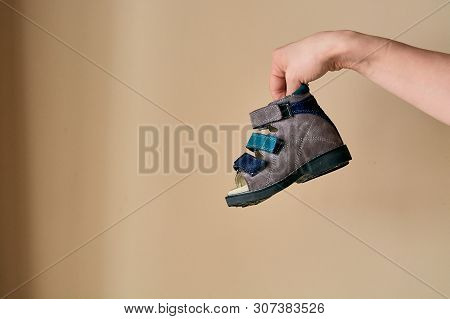 Female Is Holding Close-up A Special Childrens Orthopedic Shoe Sandals Made Of Genuine Leather.