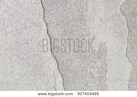 Texture Of Natural Stone With A Crack. The Background Is A Natural Stone Of Yellow Color With A Spli