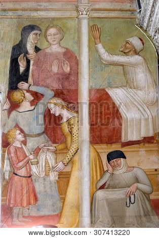 FLORENCE, ITALY - JANUARY 10, 2019: Miracle of the saint, detail from St Peter of Verona preaching, fresco by Andrea di Bonaiuto, Santa Maria Novella Principal Dominican church in Florence, Italy