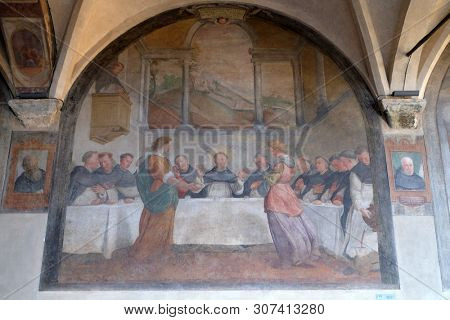 FLORENCE, ITALY - JANUARY 10, 2019: San Dominic in Mensa fed by the Angels, fresco by Santi di Tito in the cloister of Santa Maria Novella Principal Dominican church in Florence, Italy