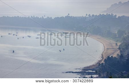 Shallow Fishing Boats Anchor At The Beach On Thick Fog Days..