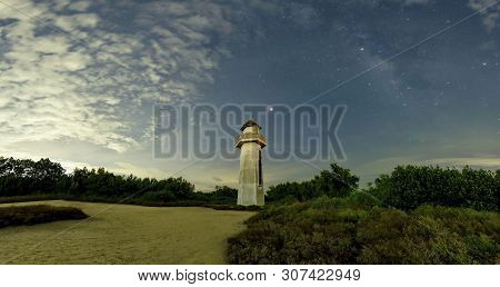 The Lighthouse Looks Neat In The Sea, The Old Lighthouse In The Wilderness. The Sky Behind Has Cloud