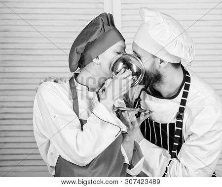 Tasty Kiss. Family Cooking In Kitchen. Secret Ingredient By Recipe. Cook Uniform. Man And Woman Chef