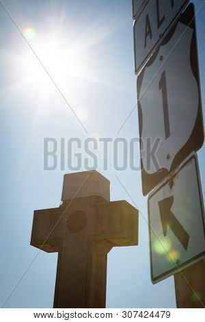 2019 BLADENSBURG MARYLAND USA FEB 25 Peace Cross: Sunflare silhouette of signs at World War I Memorial built by American Legion 1919-1925 for Prince Georges County soldiers who died in the Great War.
