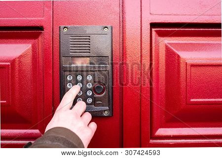 Male Hand Presses A Button On Doorbell And Intercom.