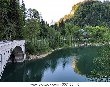 Bridge Across The Stream Schrabach (schraehbach) And On Alpine Lake Wagitalersee (waegitalersee), In