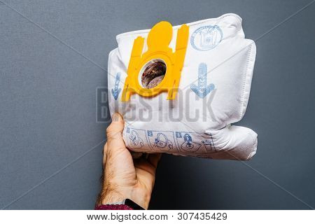 Paris, France - May 16, 2019: Man Hand Holding Against Gray Background Used Full With Dust Swirl Vac