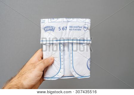 Paris, France - May 16, 2019: Man Hand Holding Against Gray Background One New Swirl Vacuum Cleaner 