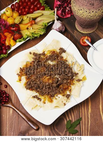 Caucasian Traditional Foor Khingal, Khinkali. Caucasian Pasta With Meat In White Plate On Wooden Tab
