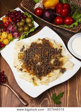 Caucasian Traditional Foor Khingal, Khinkali. Caucasian Pasta With Meat In White Plate On Wooden Tab