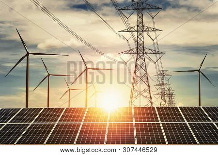 Electricity Power In Nature. Clean Energy Concept. Solar Panel With Turbine And Tower Hight Voltage 