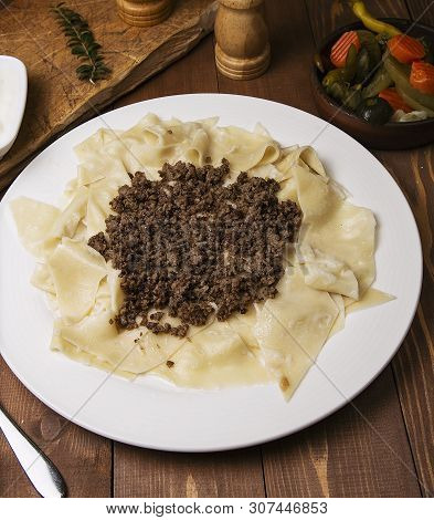 Caucasian Traditional Foor Khingal, Khinkali. Caucasian Pasta With Meat In White Plate On Wooden Tab