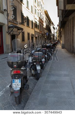 Florence/italy- April 6, 2018: A Rank Of Scooters Lined Up Along A Side Street.