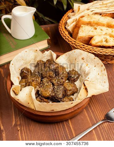 Green Grape Leaves Stuffed With Meat, Rice, Herbs, Onion And Cooked In Olive Oil, Served With Lavash