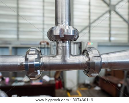 T-connection Of Stainless Steel Pipes In An Industrial Environment. Shallow Depth Of Field.