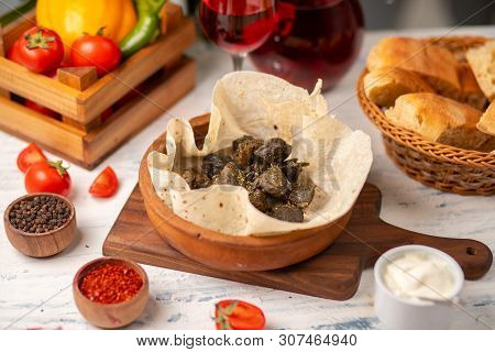 Green Grape Leaves Stuffed With Meat, Rice, Herbs, Onion And Cooked In Olive Oil, Served With Lavash