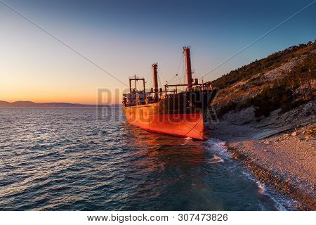 Aerial View Of Ship Run Aground On Sea Coast, Shipwreck After Storm, Drone Photo