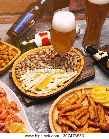 Lager Beer And Snacks On Wooden Table. Nuts, Cheese Chips, Pistachios, Crevettes - Image