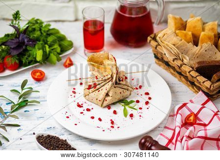Lavash Snack Roll With Cheese And Grenate Seeds, Bread, Vegetables And Sorbet On A White Plate. Snac