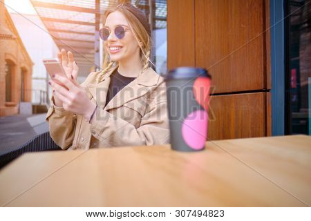 woman using smartphone in caffee shop. smart phone or mobile 