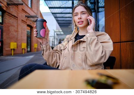 woman using smartphone in caffee shop. smart phone or mobile 