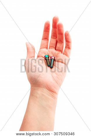 A Hand Holding A Couple Of Screws. Arm Showing Bolts, Professional Work Concept.