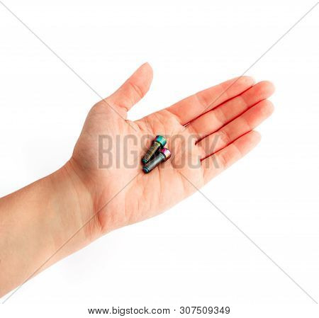 A Hand Holding A Couple Of Screws. Arm Showing Bolts, Professional Work Concept.