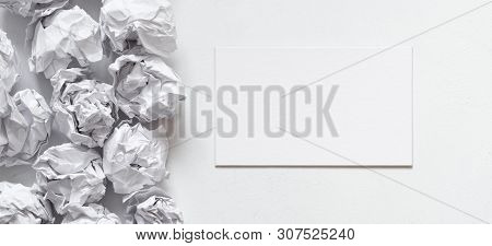 Business Idea. Flat Lay Of Blank Card And Crumpled Paper Ball Pile On White Background. Copy Space.